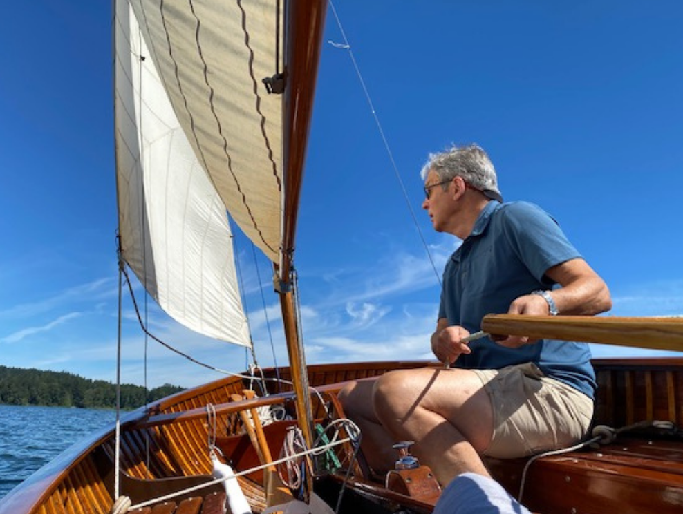 Tony Cond sailing Rufus on a clear day.